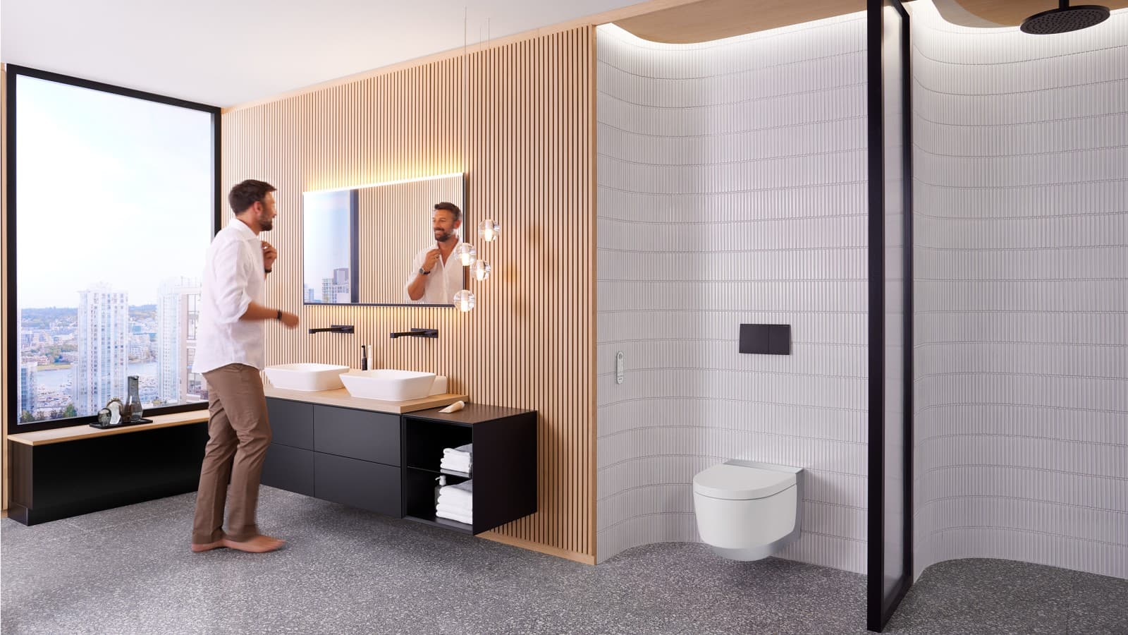 Hombre en el baño frente al espejo Geberit Option Plus, cuadrado, y el mueble de baño negro Geberit ONE (© Geberit) Hombre en el baño frente al espejo Geberit Option Plus, cuadrado, y el mueble de baño negro Geberit ONE (© Geberit)